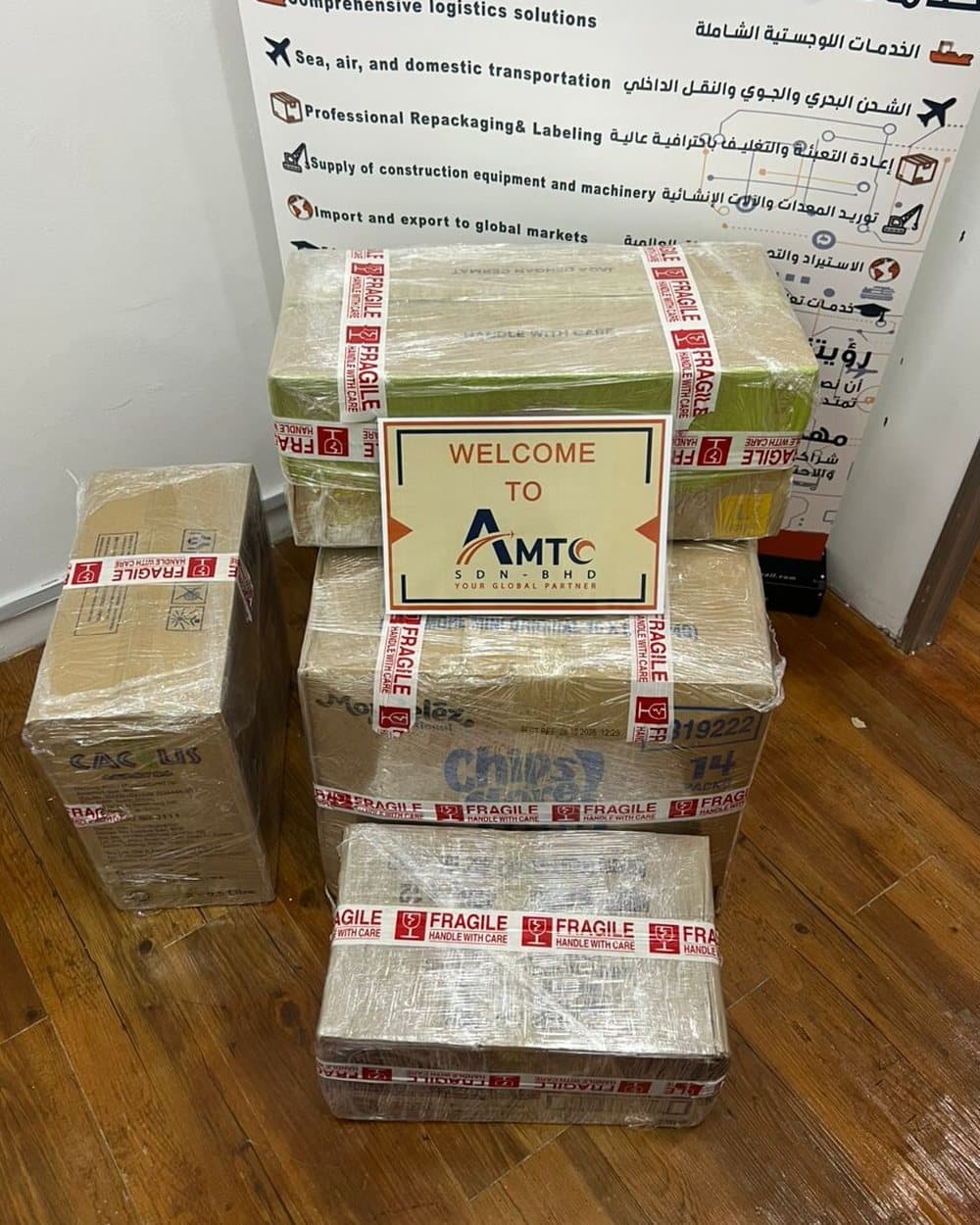 Wrapped boxes with an AMTC welcome sign