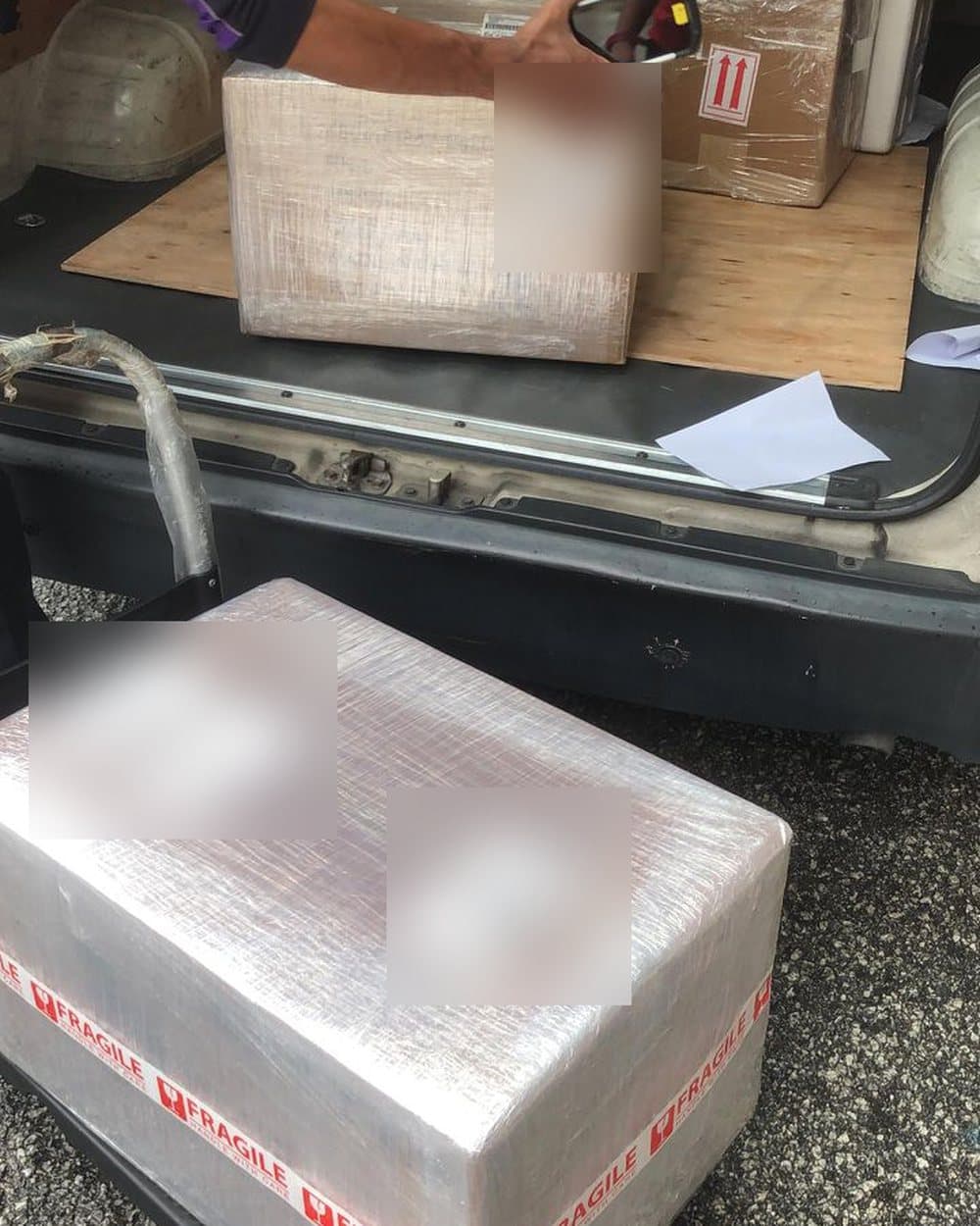 A courier collecting a wrapped box