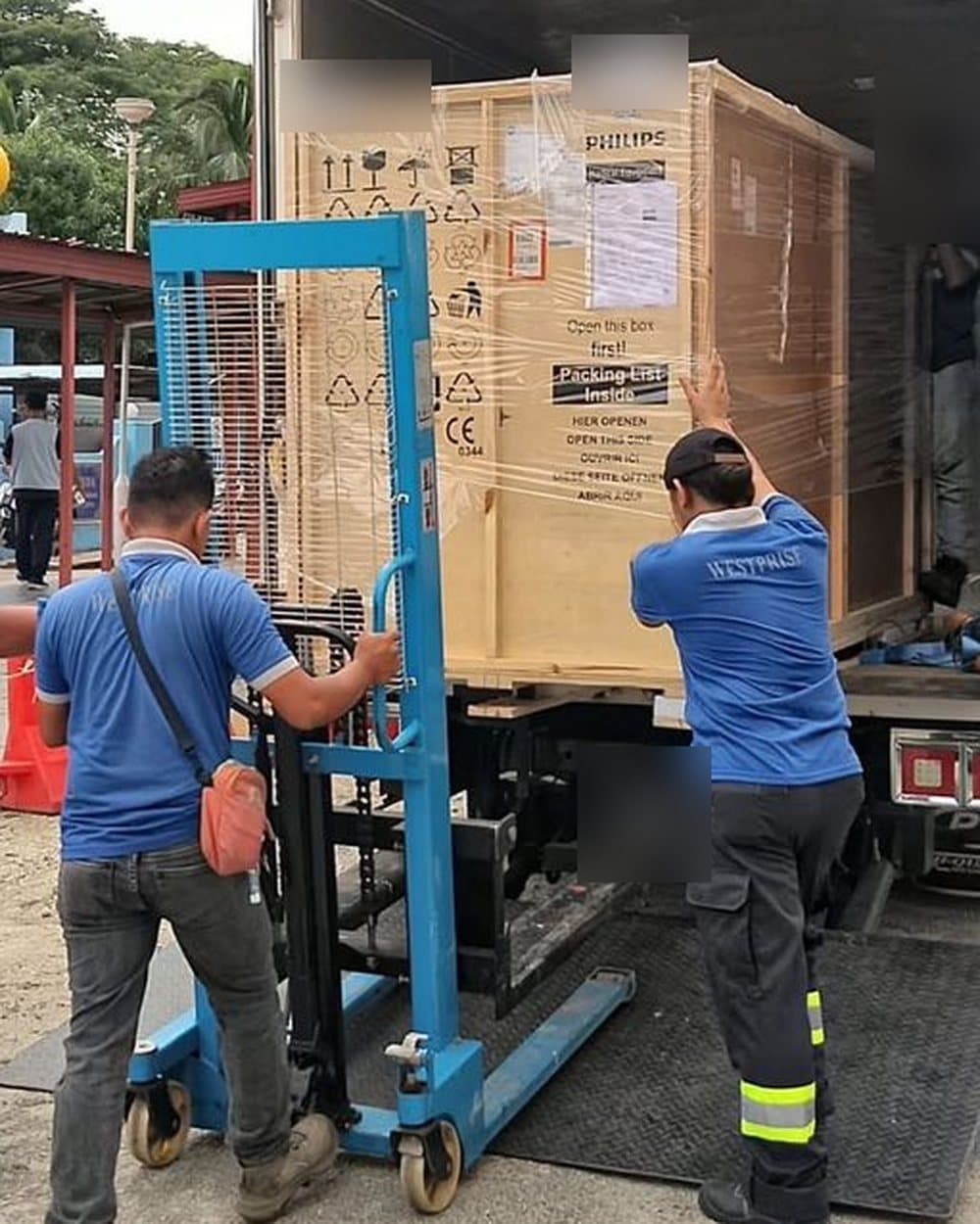 Loading a large wooden crate onto a truck