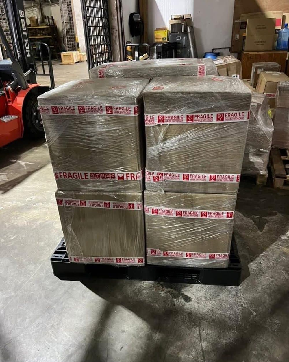 Boxes wrapped with warning tape on a pallet in the warehouse