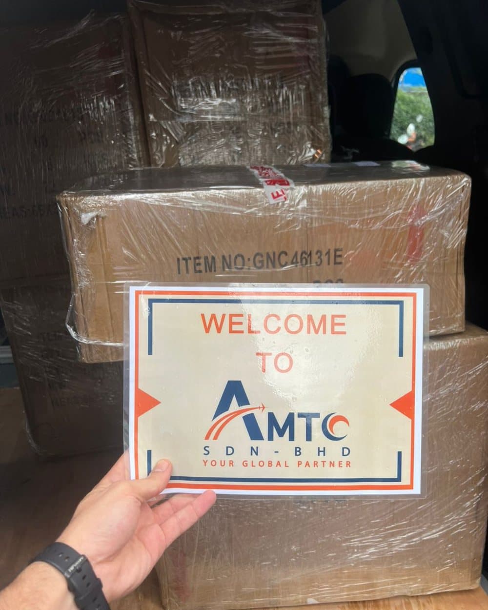 Wrapped boxes in a van, with an AMTC welcome sign